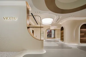 A minimalist retail storefront featuring white marble and bronze accents.