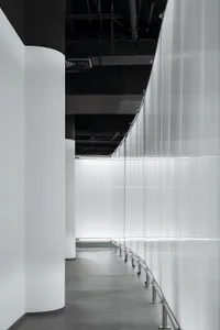 A modern, industrial-style interior space featuring metallic elements and translucent glass panels.