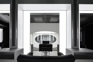 An image of a modern interior design with white glass walls and metal accents.