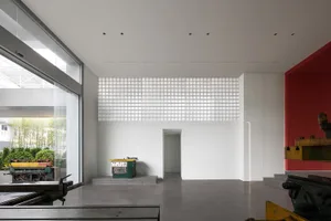 Modern minimalist office space featuring concrete floors and glass walls.