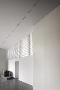 A minimalist architectural space featuring glass windows and walls.