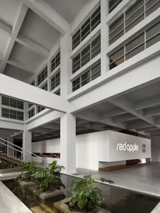Modern office space featuring concrete and glass construction with a water feature.