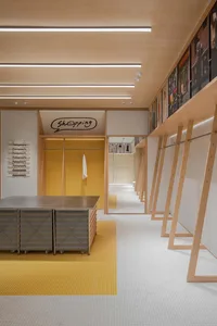 Modern retail shop interior featuring wood walls and floor with mosaic tiles