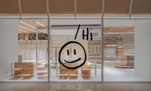 Modern retail storefront featuring minimalist design with wooden elements.