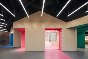 A modern classroom entrance with colorful accents and concrete materials.