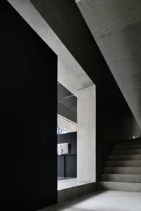 Dark modern office interior with concrete staircase