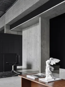 A modern office space featuring concrete and wooden elements.