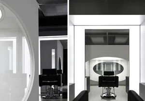 A modern salon interior featuring a sleek, minimalist design with glass walls and steel accents.