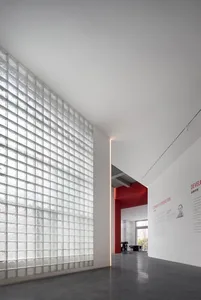 Modern minimalist interior featuring a wall clad with textured glass blocks.