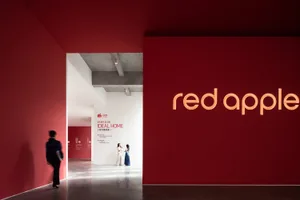 An interior design image of a minimalist retail showroom with red walls.