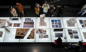 Architecture installation exhibition with models and images showcasing design decisions.
