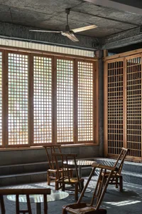 Industrial-themed restaurant interior with wooden accents and concrete ceiling