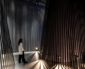 A modern minimalist interior with curtains crafted from metal, creating a unique and striking visual effect.
