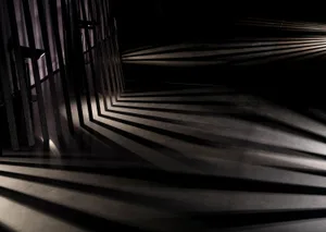A minimalist interior design featuring mirrored metallic surfaces.