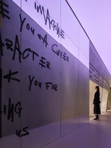 A modern interior with glass walls and concrete elements.