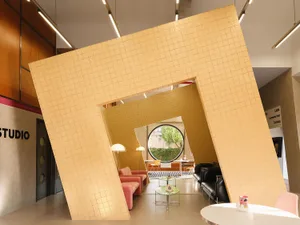 A modern interior space with a large tiled wall and colorful furniture.