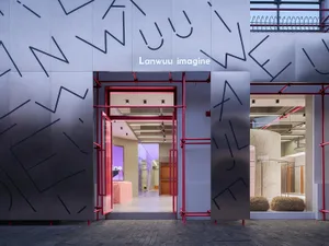 The facade of a modern retail storefront with a metallic exterior in shades of gray.