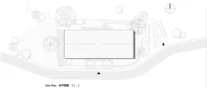 A grayscale architectural site plan detailing the layout and footprint of a building