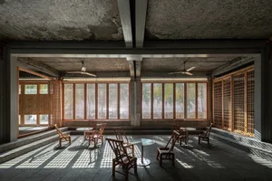 A wooden coffee shop interior with natural light streaming through windows.
