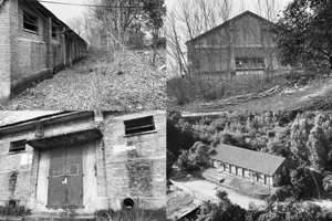 An exterior view of an abandoned industrial building made of brick.