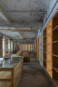 Modern industrial-style room featuring wooden furniture and shelves.