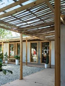 Industrial storefront with wooden canopy and glass windows.