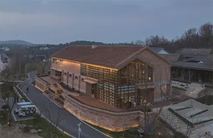 A modern building with a brick exterior during sunset