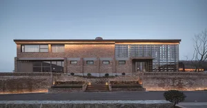 Modern building exterior with brick walls and glass windows.