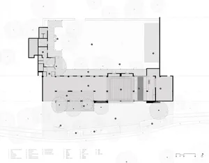 A detailed 2D architectural drawing of a modern building floor plan featuring exposed concrete elements.