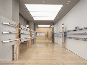 Modern interior of an optical retail store with marble surfaces and sleek, contemporary design.