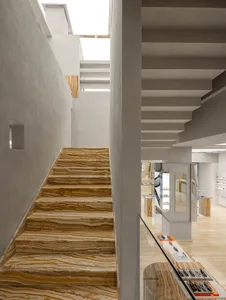 Interior of a modern retail store with marble stairs and concrete columns