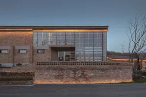 Modern storefront with brick wall and large glass windows.