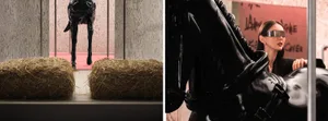 A photograph of a black plastic horse standing on a pink surface surrounded by hay bales in a barn setting.