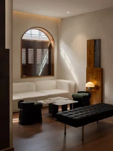 A minimalist living room featuring soft furnishings and a sleek, modern design.