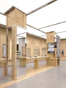 A modern retail store with minimalist design featuring marble finishes and glass fixtures.
