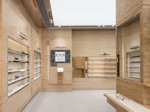 A modern retail shop with marble displays showcasing eyewear products.