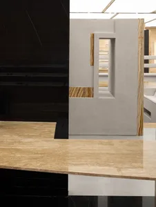 A sleek, modern storefront with a glass storefront, concrete elements, and marble accents.