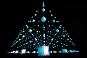 A minimalist light installation featuring numerous glass cubes suspended in the air.