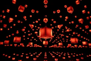Multiple red paper lanterns hanging in the air, creating an artistic and visually appealing display.
