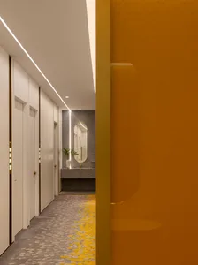 Modern hotel corridor featuring concrete flooring and modern design elements.