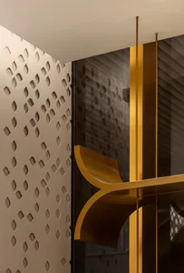 Modern interior design featuring metal columns and a patterned wall.