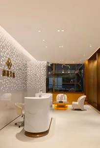 Modern office reception area with marble counter, glass display shelves, and metal accents