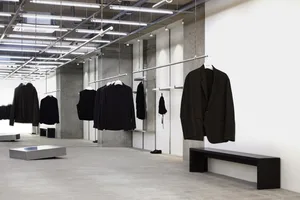 Modern retail space featuring concrete walls and metal railings.