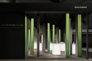 A minimalist exhibit stall featuring modern LED light columns.