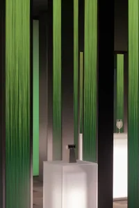 A contemporary art installation featuring modern green columns.