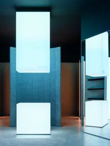 A minimalist interior space featuring concrete, steel, and glass elements.