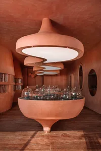 A modern restaurant interior with a sculptural clay light fixture.