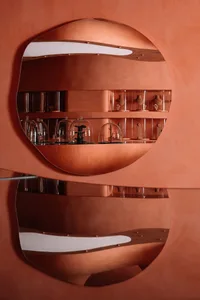 A jewelry shop display featuring metallic shelving with cloches covering jewelry items.