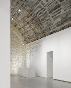 Minimalist art installation featuring metal mesh and concrete