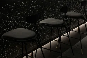 Black minimalist furniture arranged against a starry night sky background.
